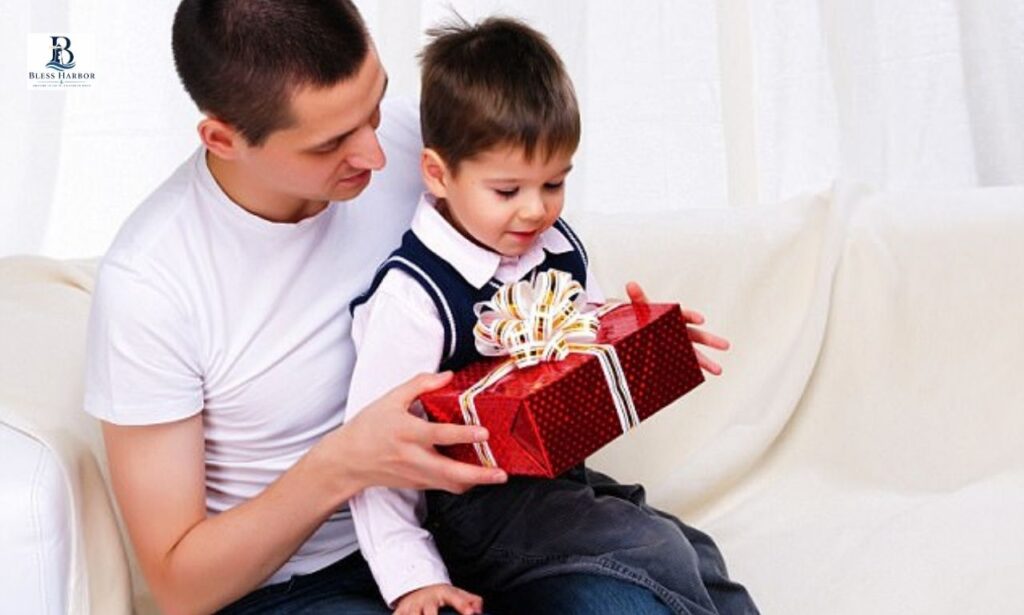 Father giving birthday gift to son